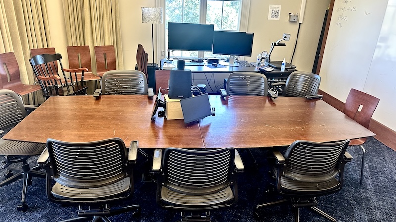Photo of the Seminar Room showing the conference table, the Kandao box, chairs, Linux machine, cookie jar, audio mixer, document camera, and Kramer rack.