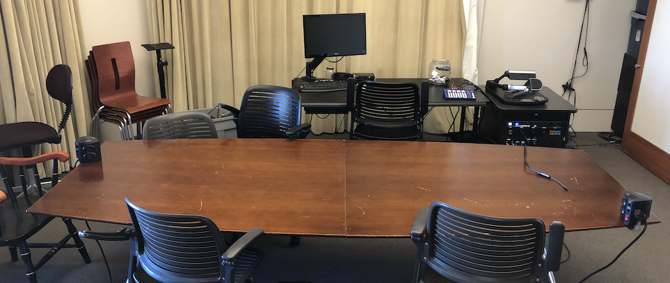 Photo of the Seminar Room showing the conference table, chairs, Linux machine, cookie jar, audio mixer, document camera, and Kramer rack.