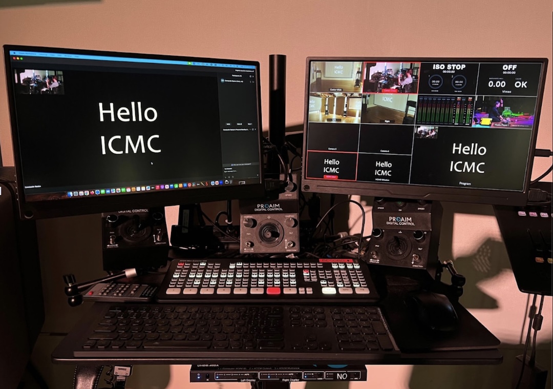 Photo of the full Stage video system, showing (top to bottom): the two video screens, the three joysticks for the camera pan/tilt units (plus the edge of the lighting board), the Blackmagic ATEM video switcher, keyboard and mouse, surface of the wheeled cart, and switcher for the content of the two screens.