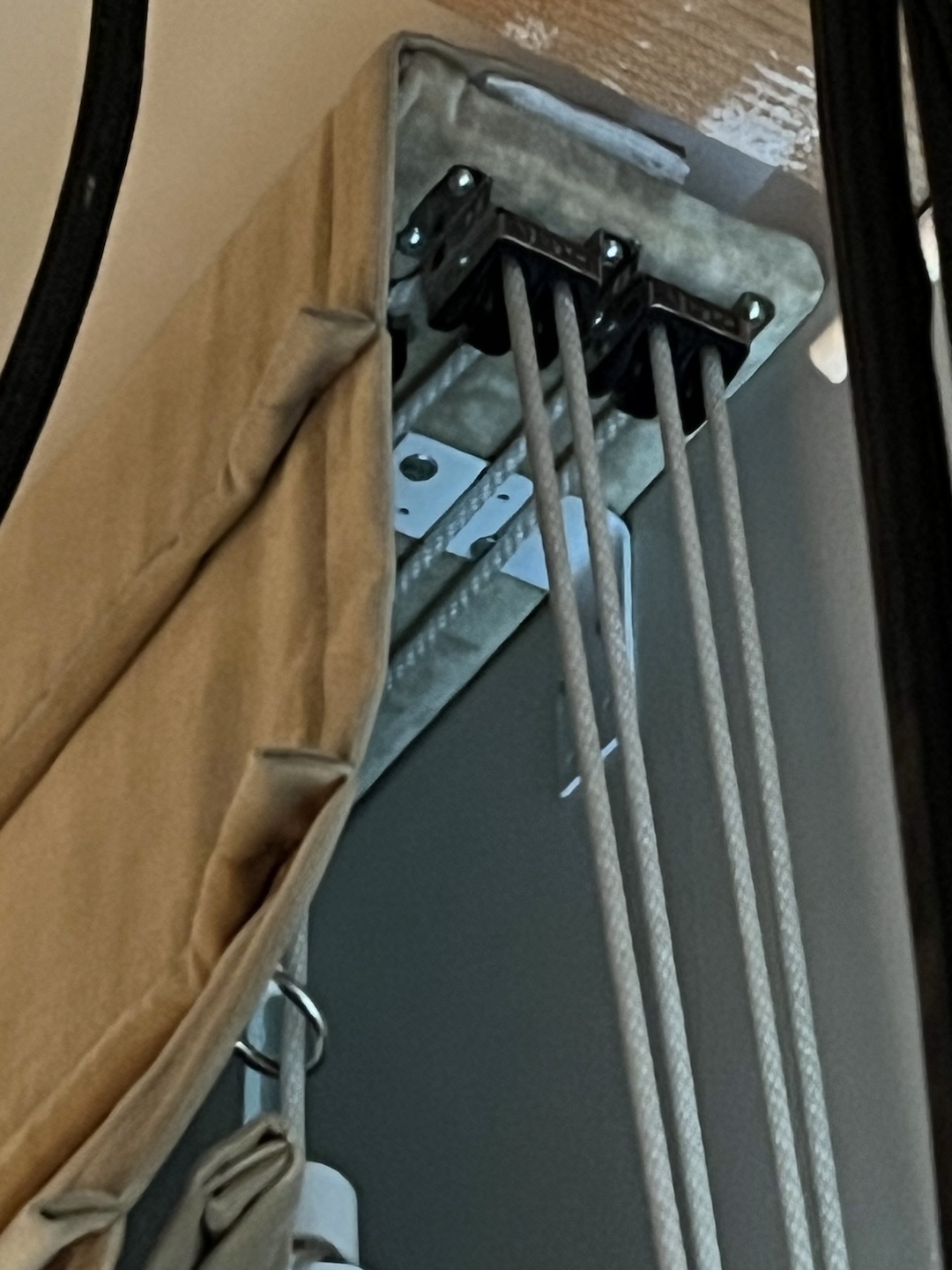 Detail photo of pulley mechanism on the side of the top of a curtain