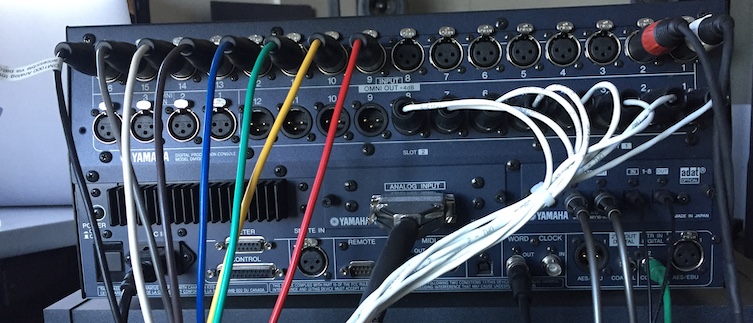 The rear of Studio E’s DM1000 mixing board, showing the many audio connections described in this section.