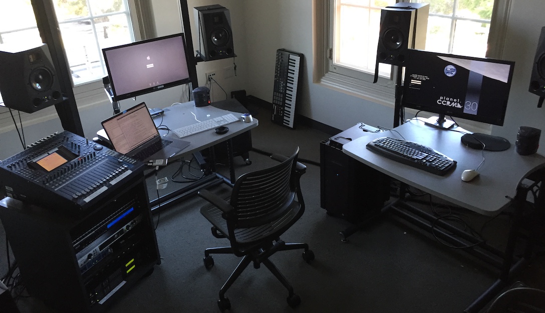 The front of Studio E with three computers (laptop, Mac, and Linux machine) in use simultaneously.